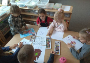Dzieci rysują misia zgodnie z wylosowanym elementem instrukcji. Zabawa pt. "Wyturlaj misia"
