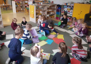 Dzieci dokunują wyboru koloru kartek potrzebnych do pracy