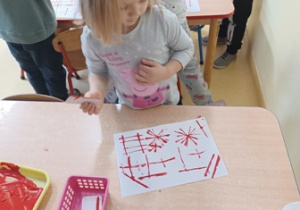 Dziewczynka obserwuje efekty swojej pracy