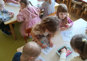 Dzieci kolorują pracę o tematyce ekologicznej.