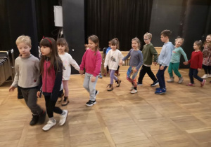 Dzieci tańczą parami w kręgu