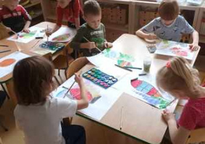 Dzieci malują farbami według własnej inwencji twórczej tło swoich prac plastycznych