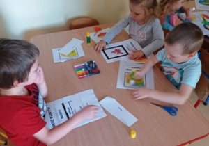 Dzieci w trakcie tworzenia książeczki montessoriańskiej