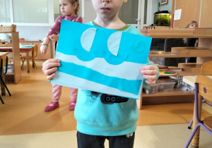 chłopiec prezentuje obrazek w odcieniach koloru niebieskiego