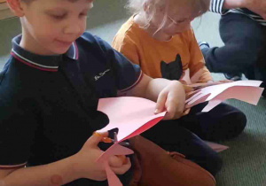 Dzieci wycinają odrysowane dłonie z papieru