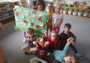 Dzieci pozują do zdjęcia prezentując swoją wspólną pracę
