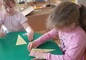Dziewczynki rysują wzory na papierowych wafelkach do lodów