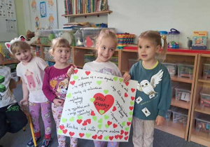 Dziewczynki trzymają plakat zrobiony dla kolegów z grupy