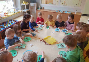 Dzieci wykonują palemki na Niedzielę Palmową