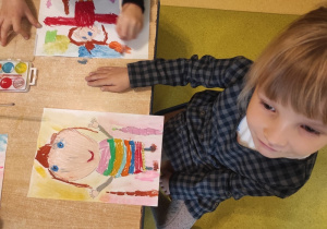 Dziewczynka rysuje portret M. Montessori.