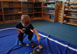 Chłopiec wybiera dzwonek stojąc na elipsie