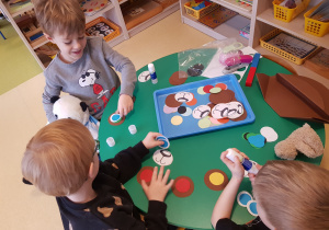 Chłopcy przygotowują czapki misiowe