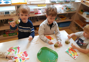 Dzieci wkładają wykałaczki w gruszkę, tworząc jeża