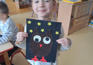 Dziewczynka prezentuje pracę pt. "Sowa"