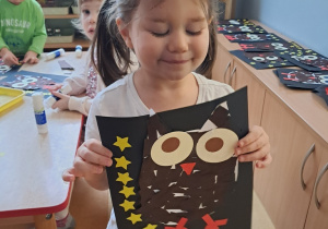 Dziewczynka prezentuje pracę pt. "Sowa"