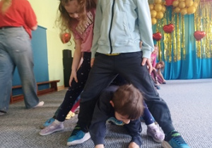 Dzieci przechodzą przez tunel utworzony przez kolegów i koleżanki