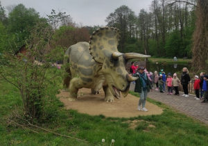 Przewodnik opowiada dzieciom o dinozaurach.