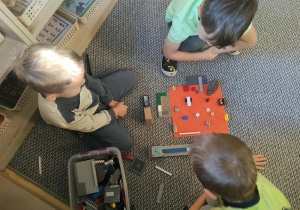 Chłopcy konstruują z klocków LEGO.