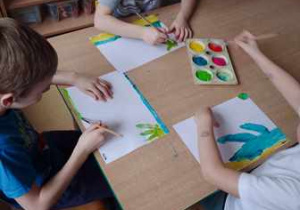 Chłopcy malują farbami temperowymi obrazy zainspirowane dziełem Vivaldiego